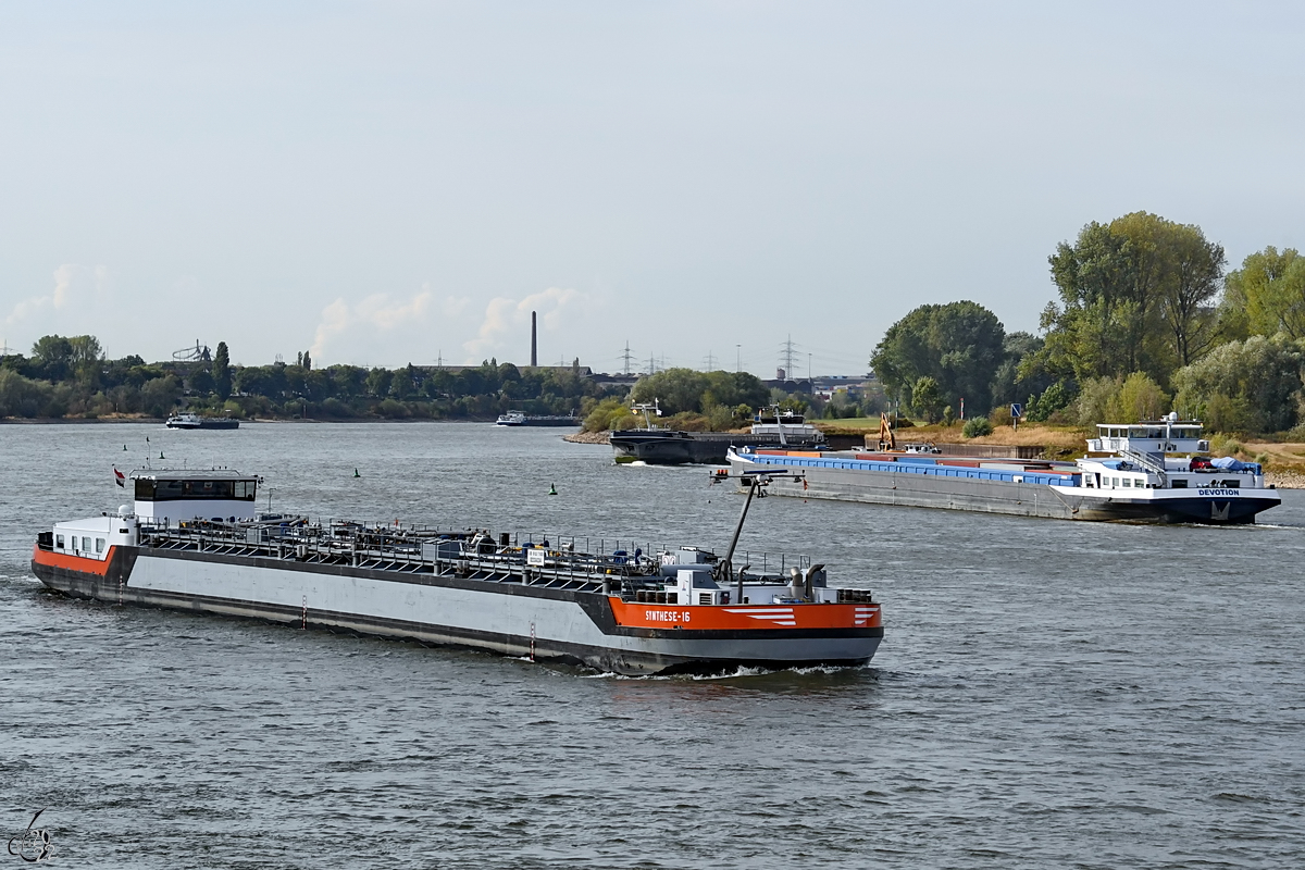 Das Tankmotorschiff SYNTHESE 16 (ENI: 02334334) auf dem Rhein, im Hintergrund das Gütermotorschiff DEVOTION (ENI: 06003854) bei der Anfahrt des D3T Duisburg Trimodal Terminals. (August 2022)