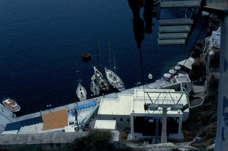 Blick aus der Kabine der Seilbahn, die vom Ankerplatz an der Insel Santorin hinauf in den Ort fhrt, auf einige Segelboote, die dort vor Anker gegangen sind (Mai 1996)