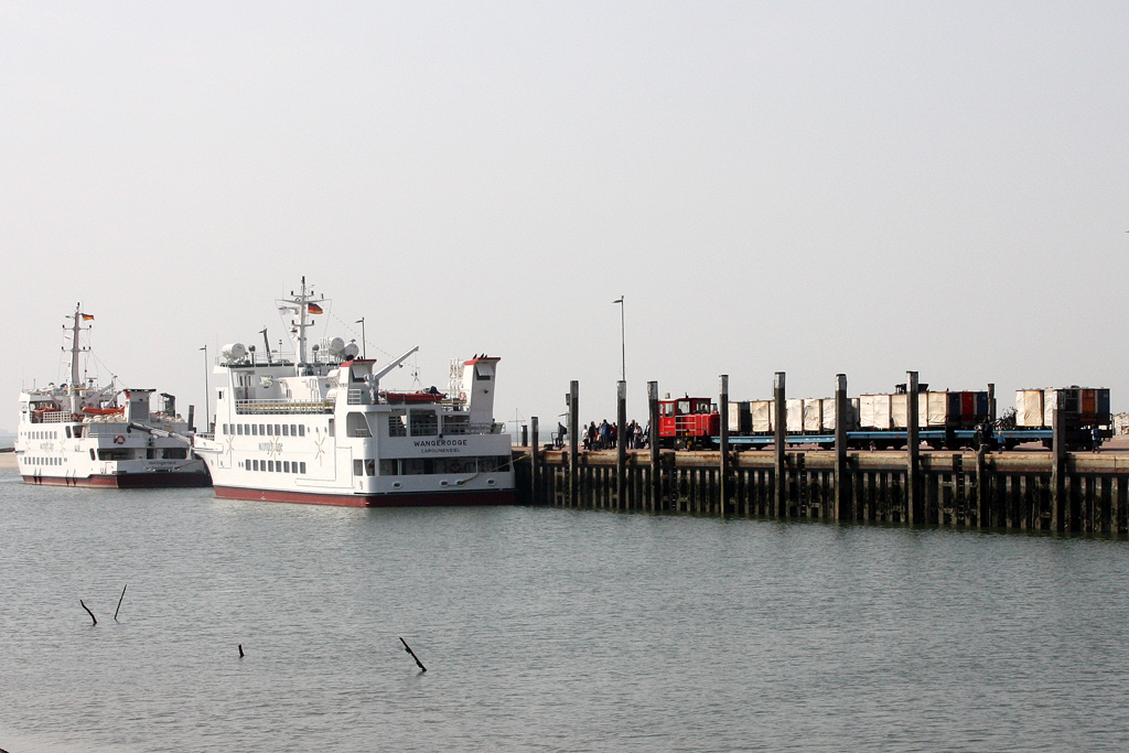 Die Fhrschiffe  Harlingerland  und  Wangerooge  liegen am Anleger Wangerooge. Von Lok 399 108-0 der Schiffdienst und Inselbahn Wangerooge werden die Gepck-Container zur Verladung auf´s Schiff bereitgestellt. 23.04.2011