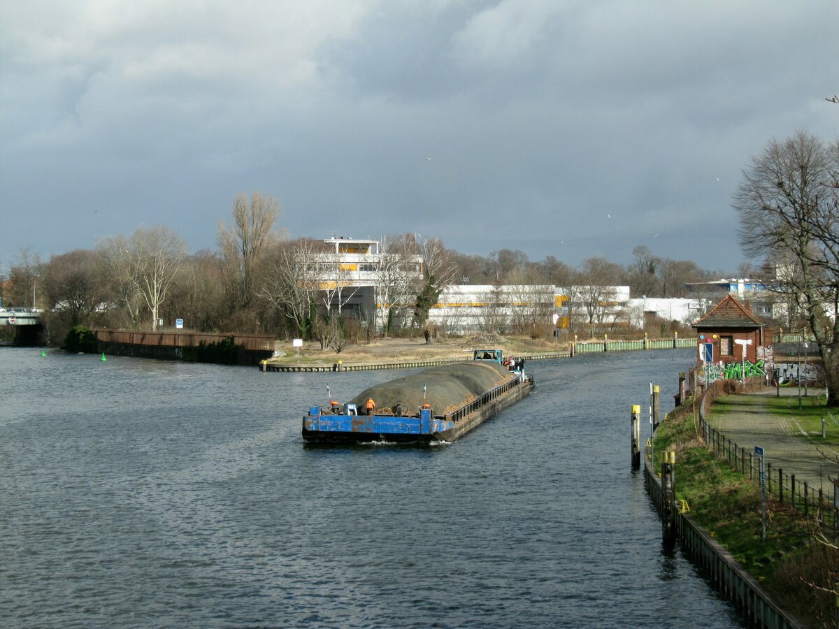 Der mit Holzhackschnitzeln beladene Leichter  UG63  (05607690 , 65 x 9,50m)  wurde am 22.02.2022 vom Schubboot Edward (05604310 , 14,05 x 8,16m) von der  SPREE  in die  HAVEL  zu Tal geschoben. Berlin-Spandau / Spreemündung.