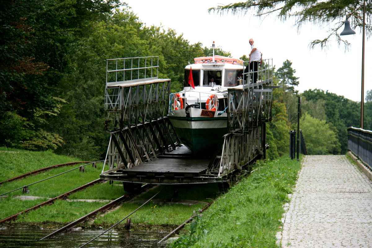 Der Trogwagen hat die M/S  Bursztyn  den Rollberg von Buczyniec hochgefahren und senkt das Schiff in das obere Kanalbecken ab; 10.09.2017