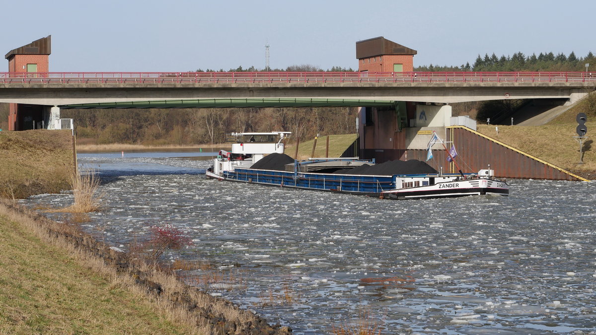 GMS ZANDER, Jesteburg (ex Andrea, ex Sabine W, ex Jan Müller (ENI 04012740) ist die Elbe zu Tal gekommen und bei Artlenburg in den Elbe-Seitenkanal eingebogen, hier wird gerade unter der B 209 das Hochwassersperrtor passiert; 20.02.2021
