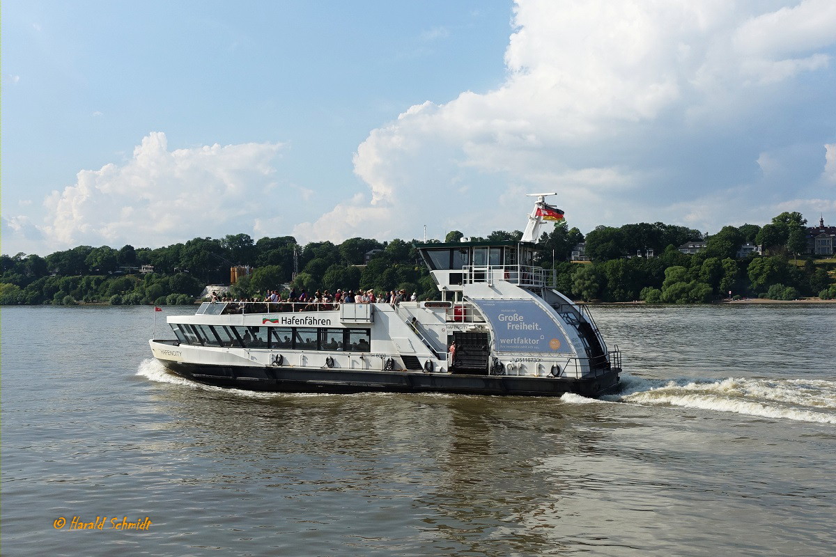 HAFENCITY (1) (ENI 051 16730) am 17.6.2023, neue Werbung: mit Eigenwerbung für Hafenfähren und Große Freiheit, Hamburg, Elbe Höhe Nienstedten  /

Einmann-Fährschiff Typ 2000 / HADAG / Lüa 29,97 m, B 8,06 m, Tg 1,5 m / 2 Diesel, Volvo-Penta D12-450, 2 Ruder-Propeller, 12 kn / 250 Pass. / gebaut 1999 bei Grube, Oortkaten, Hamburg / 02.2012 Anbau Wulstbug /
