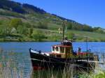 Deutschland, Rheinland-Pfalz, Merl zwischen Zell und Bullay an der Mosel,  de ol Trischen  wurde als Schleppboot für die Arbeit mit Schuten im Wattenmeer (Behördenboot) bis zur Außerbetriebsetzung Mitte der 80er Jahre eingesetzt. Daher hat sie geringen Tiefgang und einen flachen Boden, so konnte Sie im Wattenmeer ohne weiteres trockenfallen. Heimathafen war Friedrichskoog. Baujahr: 1949 - Motorisierung: luftgekühlter Deutz 6-Zylinder Diesel. Vom Mosel Radweg aus fotografiert am 23.04.2015