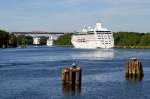 Die REGATTA wird in Krze die Levensauer Hochbrcke ber den Nord-Ostsee-Kanal in Kiel passieren, whrend das Schwesterschiff AZAMARA JOURNEY schon fast hinter der Kurve verschwunden ist. Bei solch Kreuzfahrer-Prsenz hat der Feeder dazwischen - die INES BOLTEN - es schwer, etwas Aufmerksamkeit abzubekommen. Aufgrund der Kanalerweiterung muss die Brcke 2014 einem Neubau weichen (Aufnahme vom 05.06.10).