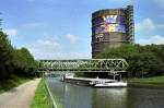 Rhein-Herne-Kanal. Motorschiff  Spree  hat Oberhausens Wahrzeichen, den Gasometer, passiert (4. Juni 2007). Der Gasometer dient auch als Litfaßsäule. Gerade wird Werbung für den Movie Park in Bottrop angebracht.