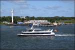 Fahrgastschiff  Rostocker 7  bei einer Hafenrundfahrt vor der Feuerwache II und dem Schlepperstützpunkt der Fairplay Towage am 22.06.14 im Überseehafen Rostock. Fotografiert an Bord der Fähre  Prins Joachim .