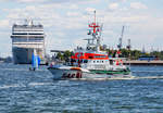 SAR Seenotrettungskreuzer VORMANN JANTZEN  im Warnemünder Hafen, im Hintergrund MSC Kreuzfahrtschiff ORCHESTRA.