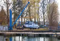Mit einem Boots-Hebekran wird ein Motorboot im Warener Yacht-Hafen zu Wasser gelassen. - 02.04.2014
