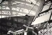 AL-MALIK SAUD AL -AWAL (IMO 5500760) (Bugpartie über der  Taufkanzel) am 3.6.1954 Stapellauf bei Howaldtswerke Hamburg, Bau-Nr. 883,  / (Scan vom Foto, von für Taufgäste frei zugänglichem Gelände)
Turbinen-Tankschiff (damals der größte Tanker der Welt)  / Lüa 236,4 m, B 29,2 m / Tragfähigkeit: 50.000 t / Eigner: Olympic Maritim (Aristoteles Onassis) / 9.6.1966 in Salinas (Venezuela) brannte das Achterschiff nach einer Explosion im Maschinenraum aus, per Schlepp nach Teneriffa (Kanaren) um das restliche an Bord befindliche Rohöl zu löschen, Dezember 1967 per Schlepp nach Hamburg, Achterschiff Abbruch, Vorderschiff Umbau zum Öllagerschiff, per Schlepp in den Golf