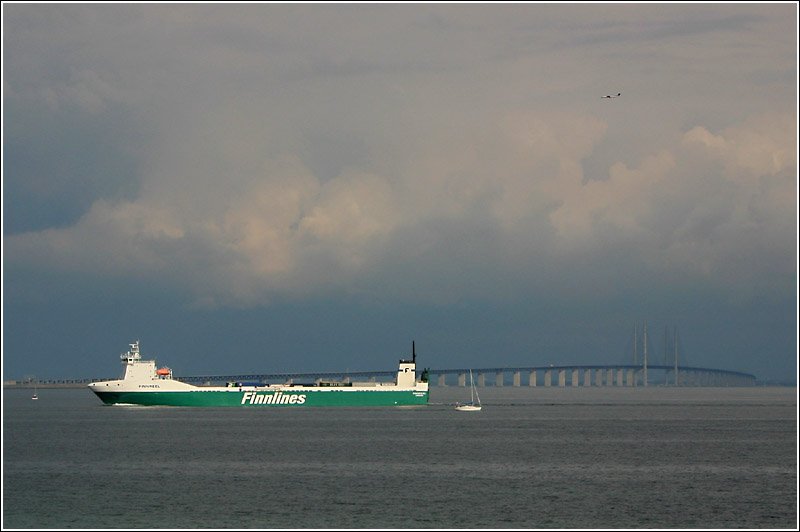 Zu Wasser, zu Lande und in der Luft: am resund sdlich von Kopenhagen treffen die verschiedensten Verkehrsmittel zusammen. Eine Fhre auf dem Weg nach Kopenhagen, die resundbrcke fr den Auto- und Eisenbahnverkehr und rechts oben ist ein Flugzeug im Landeanflug? auf den Kopenhagener Flughafenn erkennbar. 26.8.2006 (Matthias)